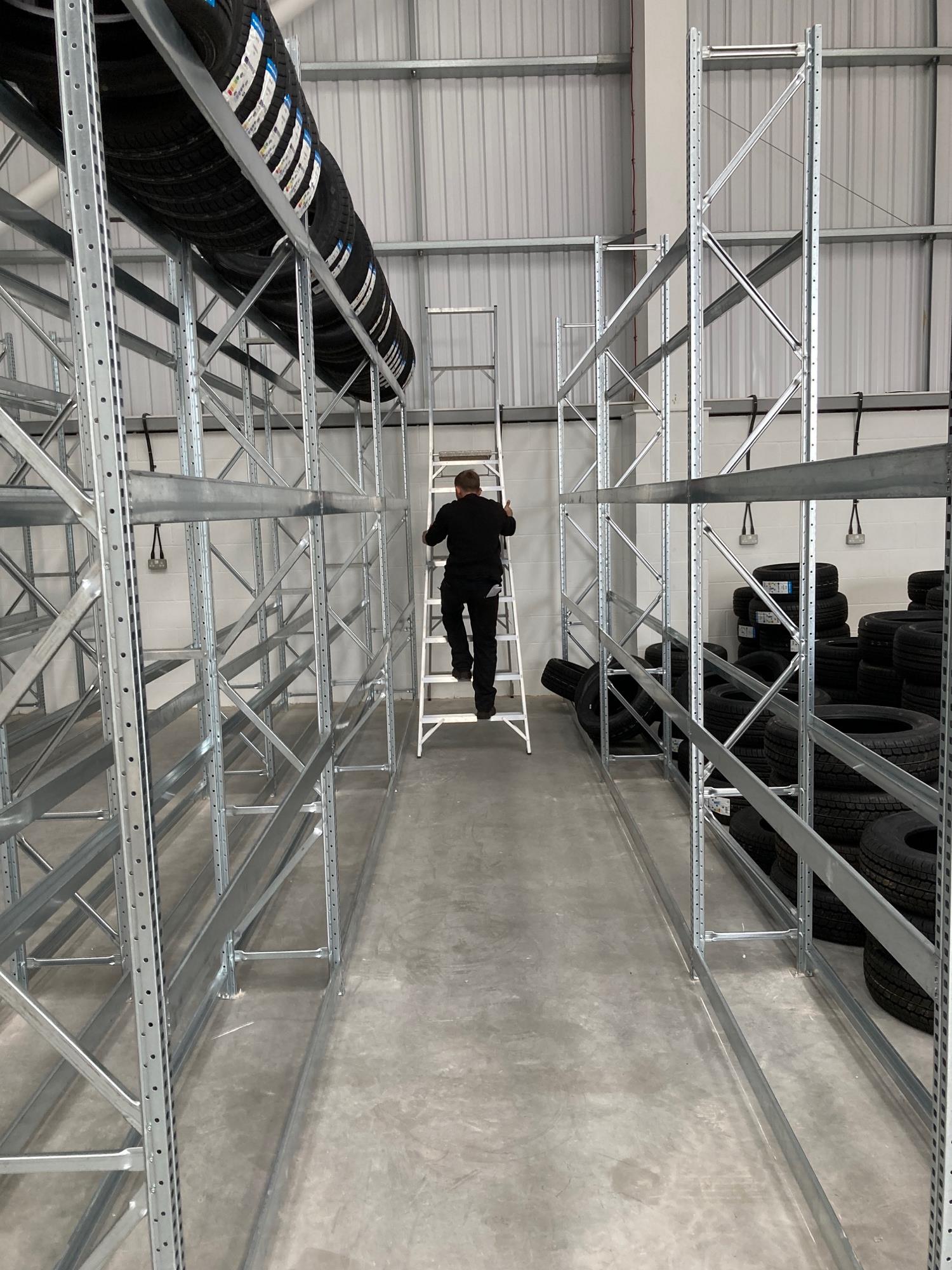 Tyre racks and employee on the ladder